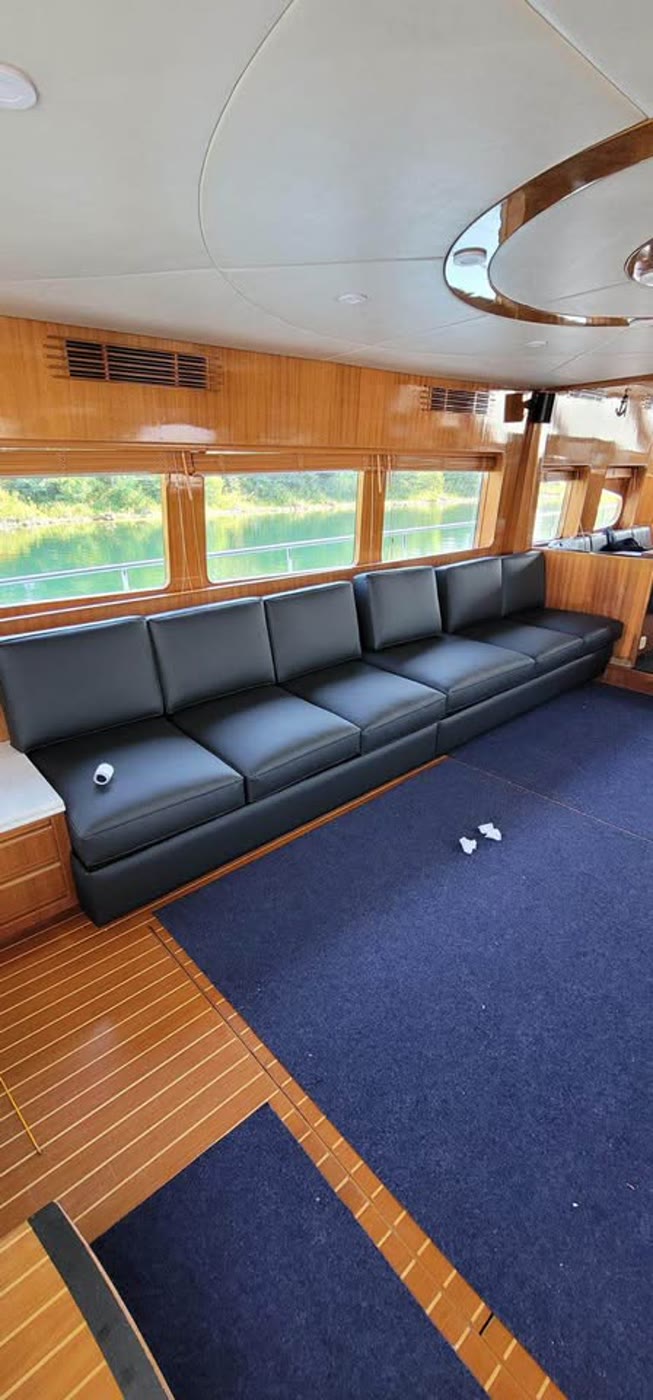 Custom black marine-grade boat seat cushions in a yacht saloon